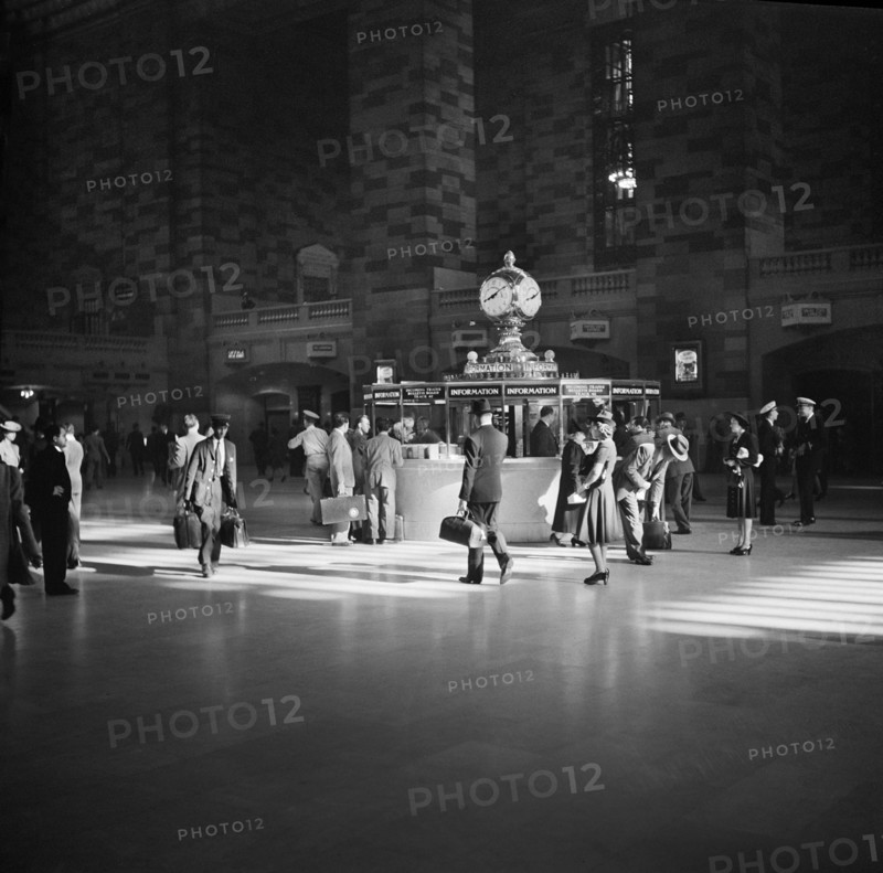 Group of People gathered around Information Booth
