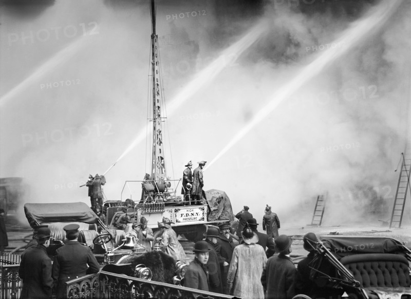 Fireman spraying water on burning building