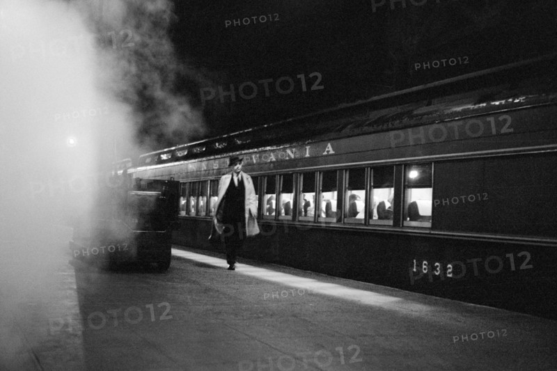 Man walking on platform next to train