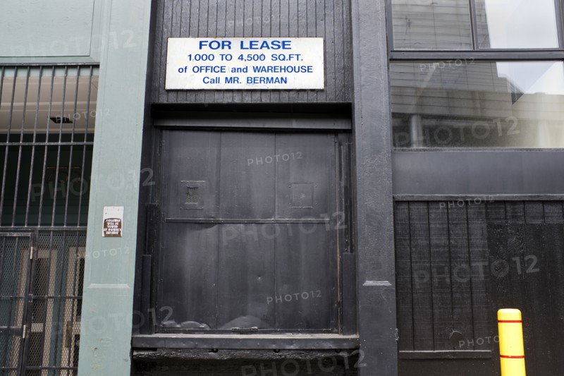 For Lease Sign above Black Loading Dock Door