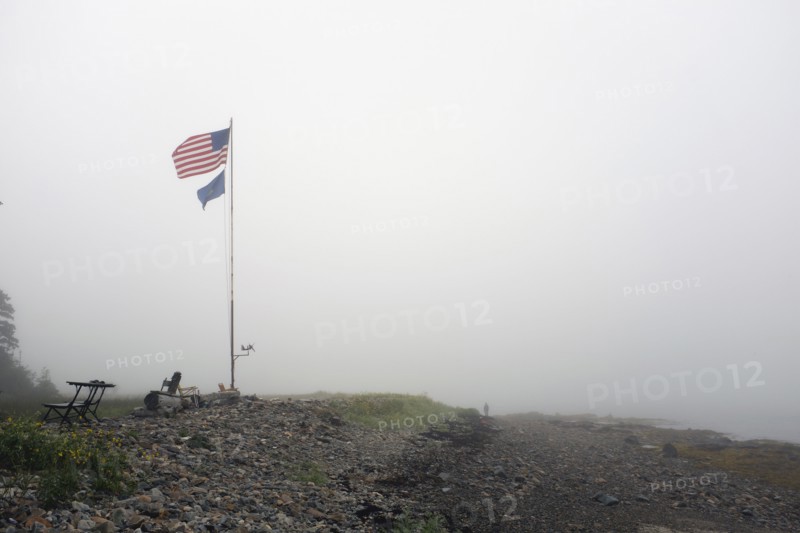 American Flag blowing in Wind on Foggy Beach