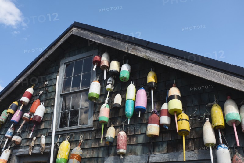 Lobster Trap Buoys hanging on side of Rustic Building