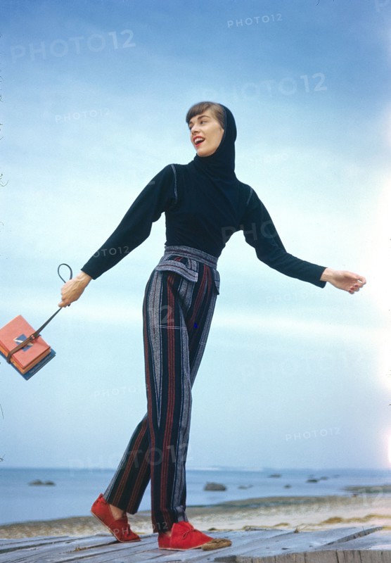 Fashionable Young Adult Woman in Striped Slacks and Hooded Top