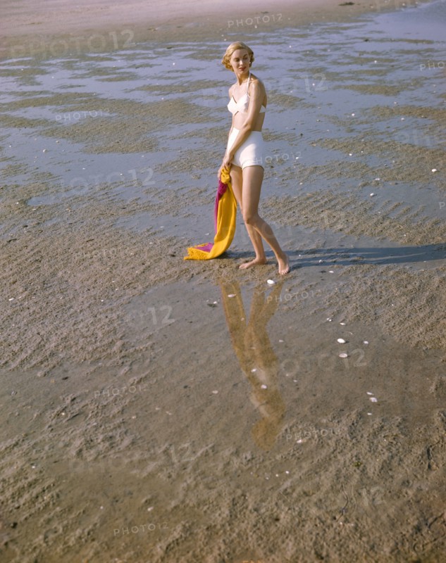 Portrait of Woman in Two-Piece White Bathing Suit on Beach