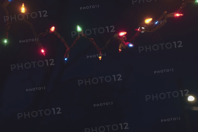 Christmas lights draped along Front Porch at Night