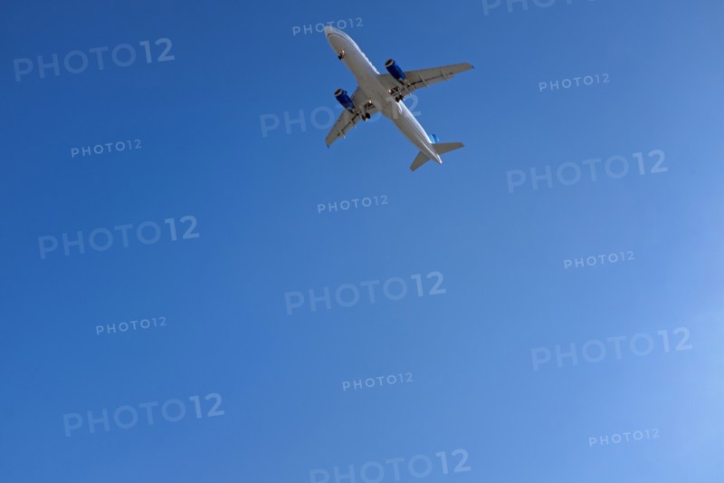 Low Angle View of Commercial Airplane against Blue Sky