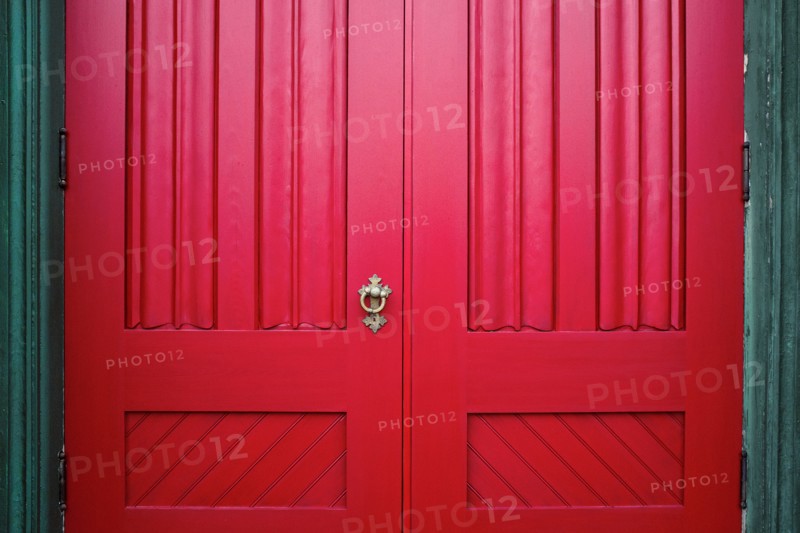 Red Wood Doors with Ornate Metal Handle