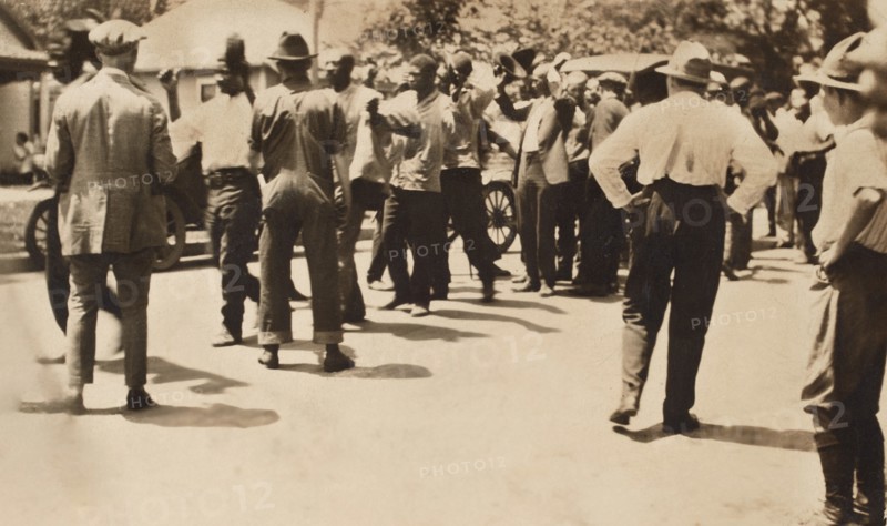 Detained African American men with Hands raised