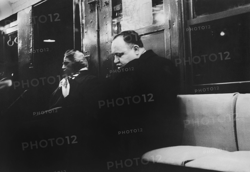 Man and Woman sitting on Subway Seat