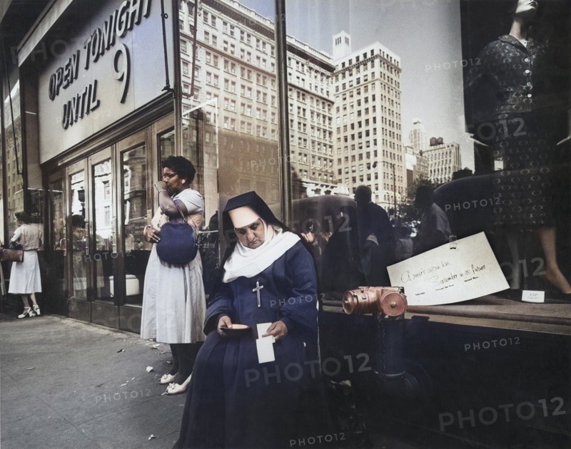 Nun sitting on Sidewalk seeking Charity