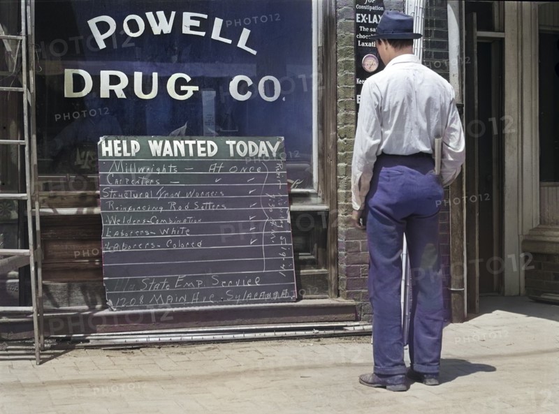Man looking at Help Wanted Sign in Store Window