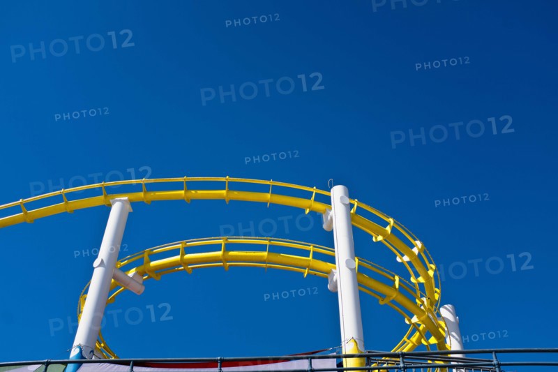 Low Angle View of Yellow Roller Coaster against Blue Sky