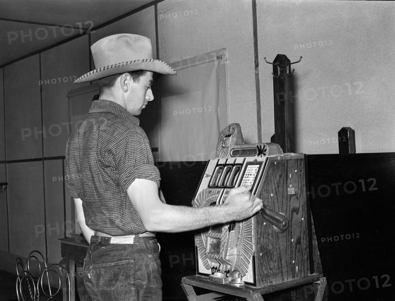 Cowboy playing slot machine