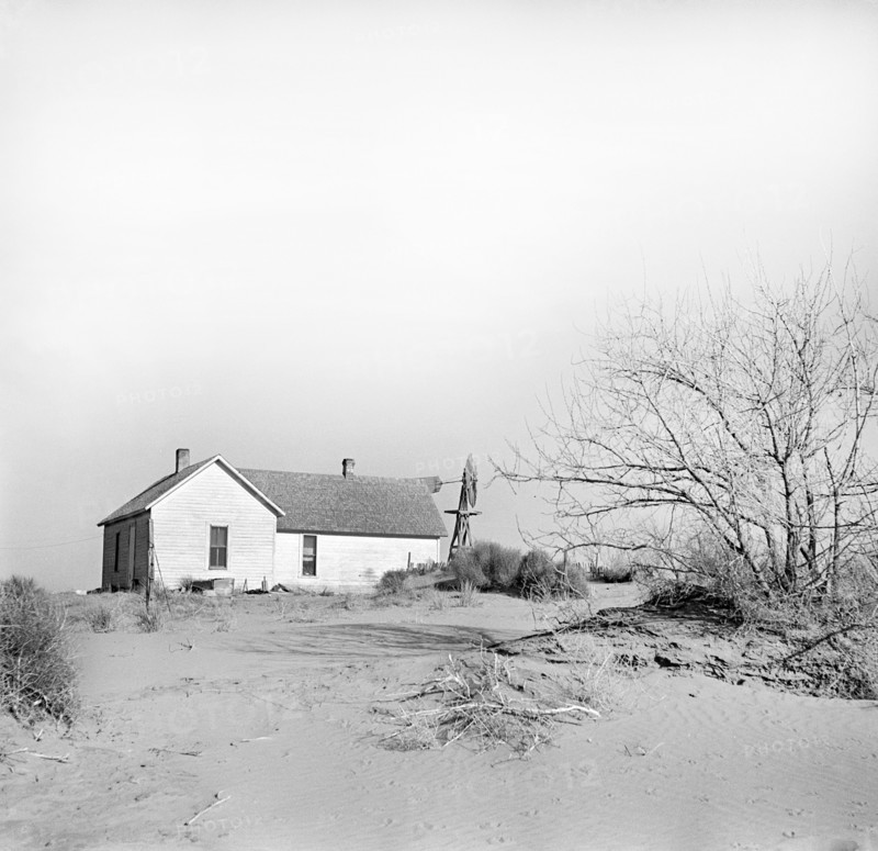 Shifting drifts of soil forcing farmer to abandon his home