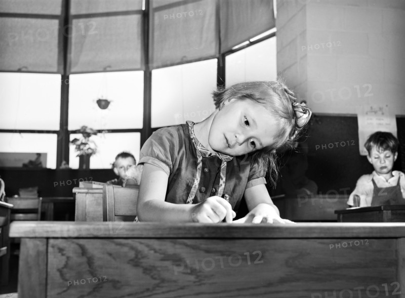 Young girl drawing picture at nursery school