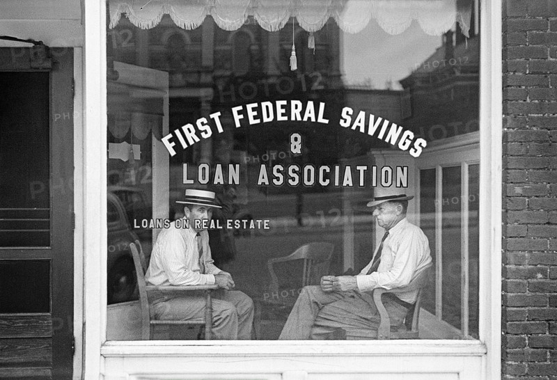 Two men sitting in window