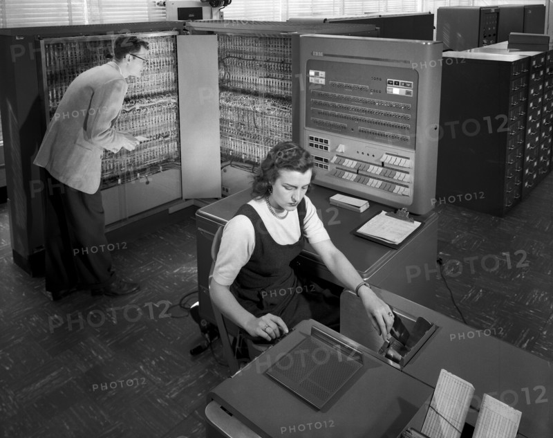 Man and woman working with IBM type T04 electronic data processing machine