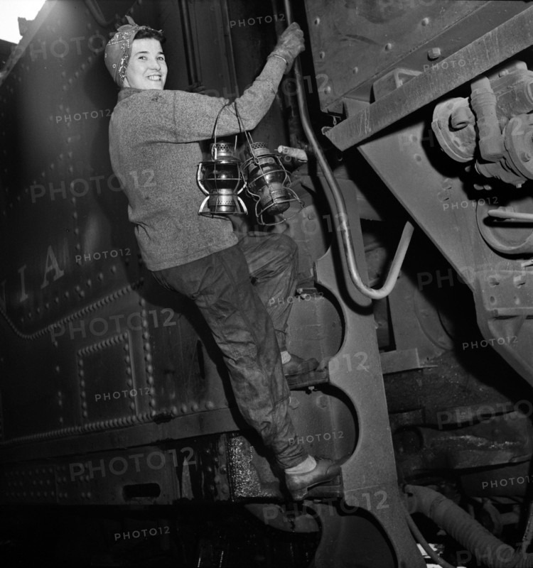 Mrs. Mary Ankrom, twenty-eight, mother of six children, employed at Pennsylvania Railroad engine house as a locomotive preparer, earning fifty-eight cents per hour. Her father takes care of her children while she is working, Pitcairn, Pennsylvania, USA, Marjory Collins, U.S. Office of War Information, May 1943