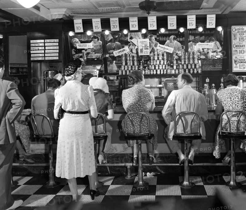 Rear view of lunchtime crowd at noon, People's Drugstore, G Street N.W., Washington, D.C., USA, Marjory Collins, U.S. Office of War Information, July 1942War Information