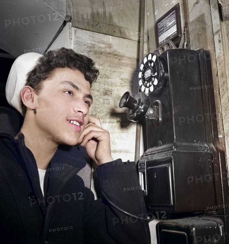 16-year-old teen boy who is in U.S. Naval Reserve talking on pay telephone, New York City, New York, USA, Marjory Collins, U.S. Office of War Information, January 1943
