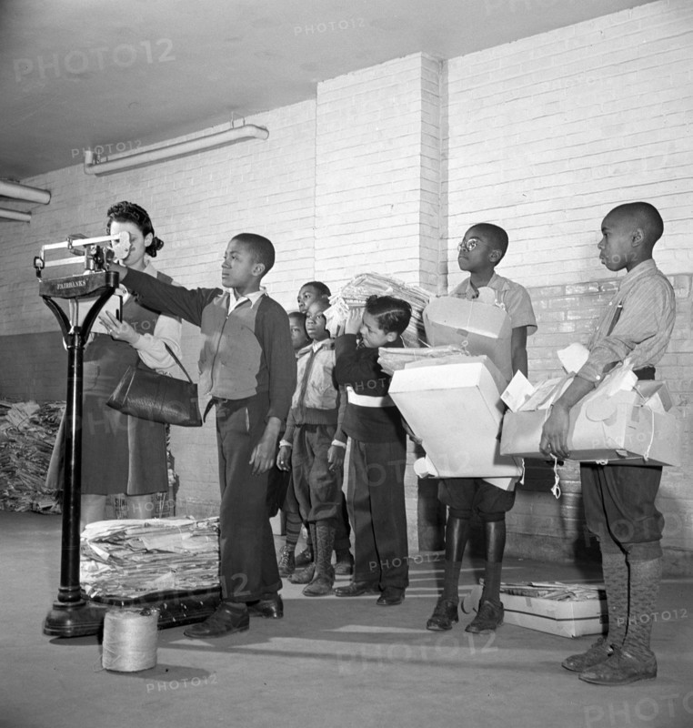 Students lined up to weigh collected scrap paper at school during Scrap Salvage Campaign, Victory Program, Washington, D.C., USA, Marjory Collins, U.S. Office of War Information, March 1942