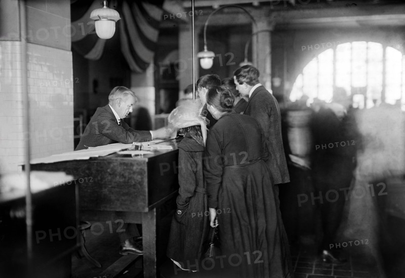 Group of arriving immigrants in examination room, Ellis Island, New York City, New York, USA, Bain News Service, 1920