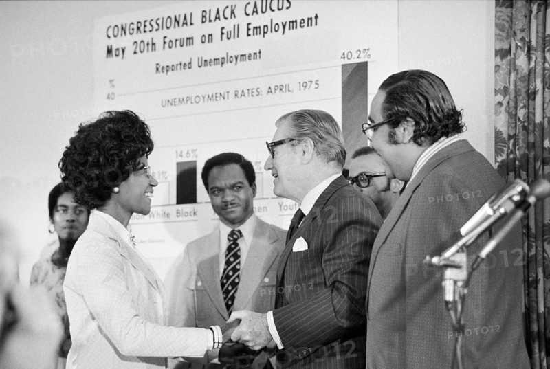 U.S. Vice President Nelson Rockefeller shaking hands with Shirley Chisholm, member of Congressional Black Caucus, as other members Charles Rangel and Walter Fauntroy look on during full employment forum, Washington, D.C., USA, Thomas J. O'Halloran, U.S. News & World Report Magazine Photograph Collection, May 20, 1975