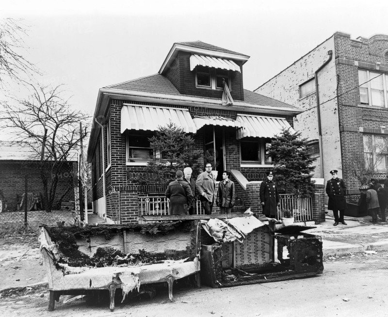 Exterior view of the home of Malcolm X after it was firebombed, remains of charred furniture in foreground, 23-11 97th Street,, East Elmhurst, Queens, New York City, New York, USA, Stanley Wolfson, New York World-Telegram and the Sun Newspaper Photograph Collection, February 14, 1965
