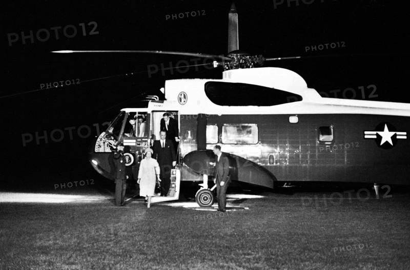 U.S. President Lyndon Johnson and First Lady Claudia 'Lady Bird' Johnson arriving on South Lawn from Dallas, Texas, via Andrews Air Force Base, Secretary of Defense, Robert S. McNamara, exiting U.S. Army helicopter behind President Johnson; Secret Service agent, Rufus Youngblood, standing right of stairs, White House, Washington, D.C., USA, Robert Knudsen, White House Photographs, November 22, 1963