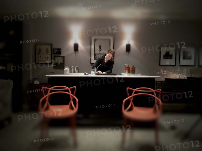 Mid-adult woman working at fancy cocktail bar