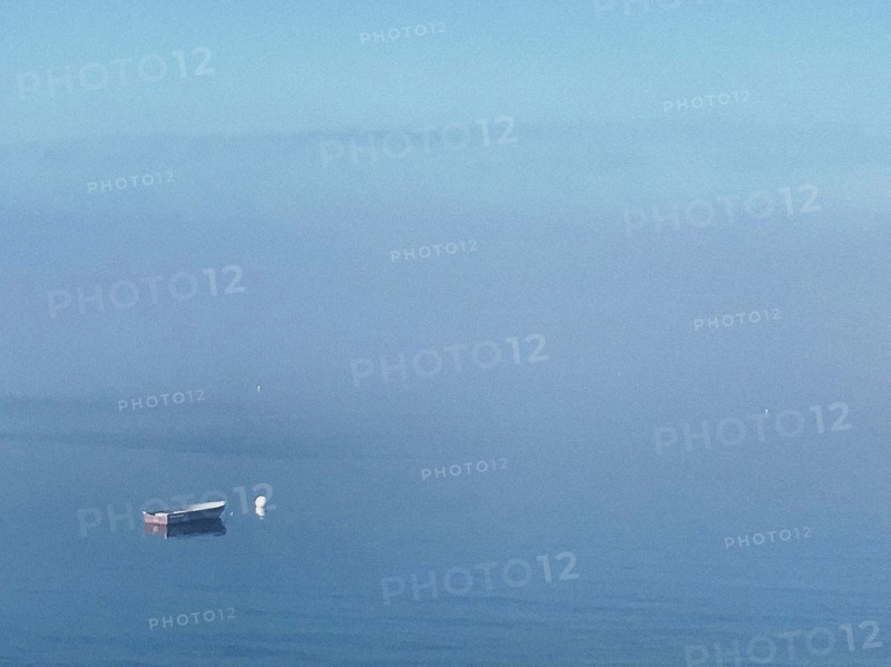 Moored rowboat at sea