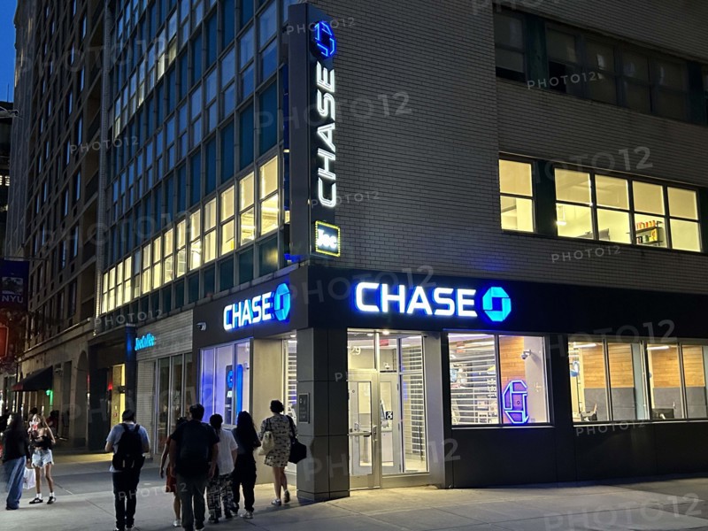 Chase retail bank office, building exterior and street scene at night, New York City, New York, USA