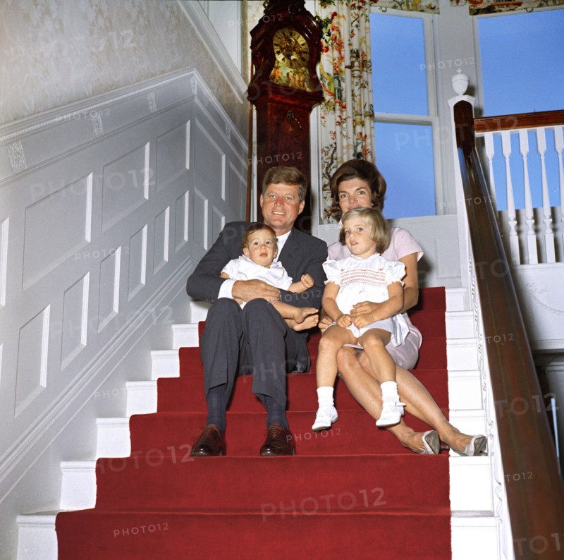 U.S. President John Kennedy and First Lady Jacqueline Kennedy sit with their children, John Kennedy, Jr. and Caroline Kennedy, on stairs inside Auchincloss home at Hammersmith Farm, Newport, Rhode Island, USA, Robert Knudsen, White House Photographs, September 29, 1961