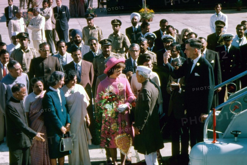 U.S. First Lady Jacqueline Kennedy (center, wearing pink) being greeted by Prime Minister of India, Jawaharlal Nehru, upon her arrival at Palam Airport, Delhi, India, Cecil Stoughton, White House Photographs, March 12, 1962
