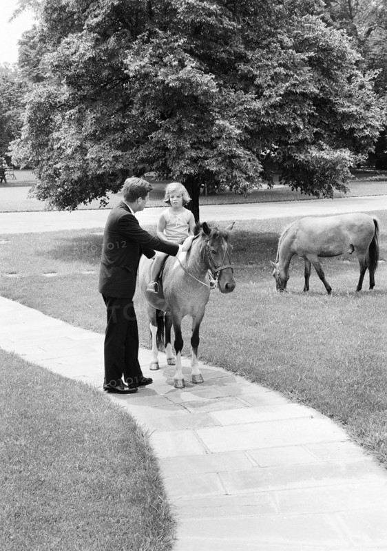 U.S. President John Kennedy with his daughter Caroline Kennedy and Caroline's pony, Macaroni, South Lawn pathway, White House, Washington, D.C., USA, Robert Knudsen, White House Photographs, June 22, 1962