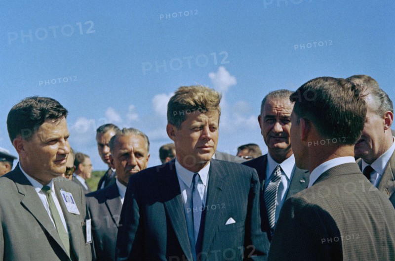 U.S. President John F. Kennedy visiting with astronaut Commander Walter M. Schirra (back to camera), with U.S. Vice President Lyndon Johnson in background, during tour of Mercury-Atlas Launch Complex, Cape Canaveral Air Force Station, Cape Canaveral, Florida, USA, Cecil Stoughton, White House Photographs, September 11, 1962