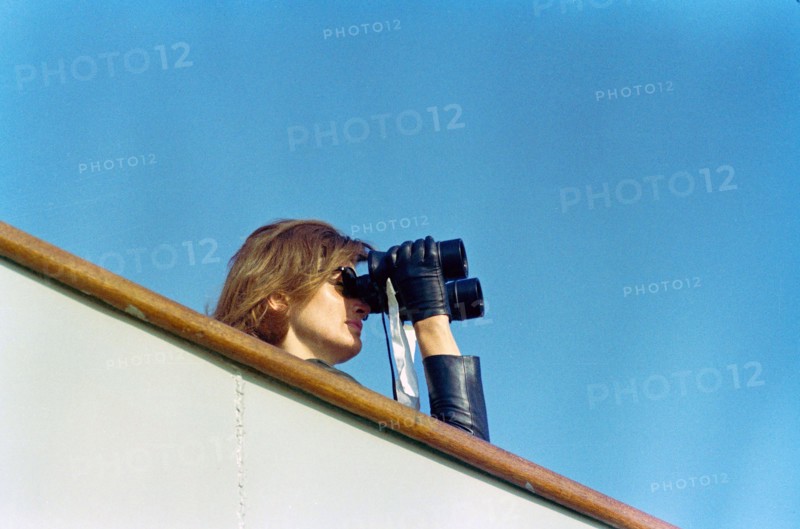 U.S. First Lady Jacqueline Kennedy watching through binoculars fourth  race of America's Cup from aboard USS Joseph P. Kennedy, Jr., Newport, Rhode Island, USA, Cecil Stoughton, White House Photographs, September 22, 1962