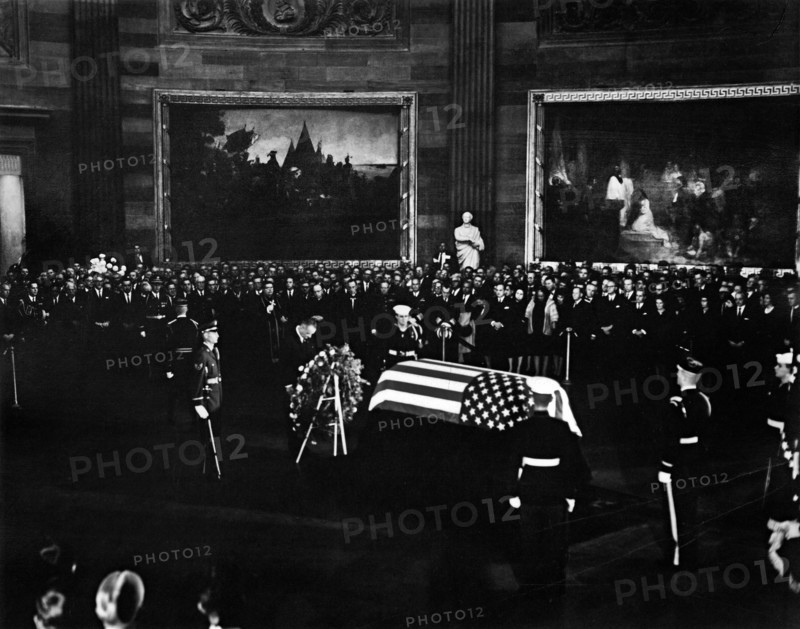 U.S. President Lyndon Johnson standing with bowed head at U.S. President John F. Kennedy's flag-draped casket in center of Rotunda, U.S. Capitol Building, Washington, D.C., USA, Abbie Rowe, White House Photographs, November 24, 1963