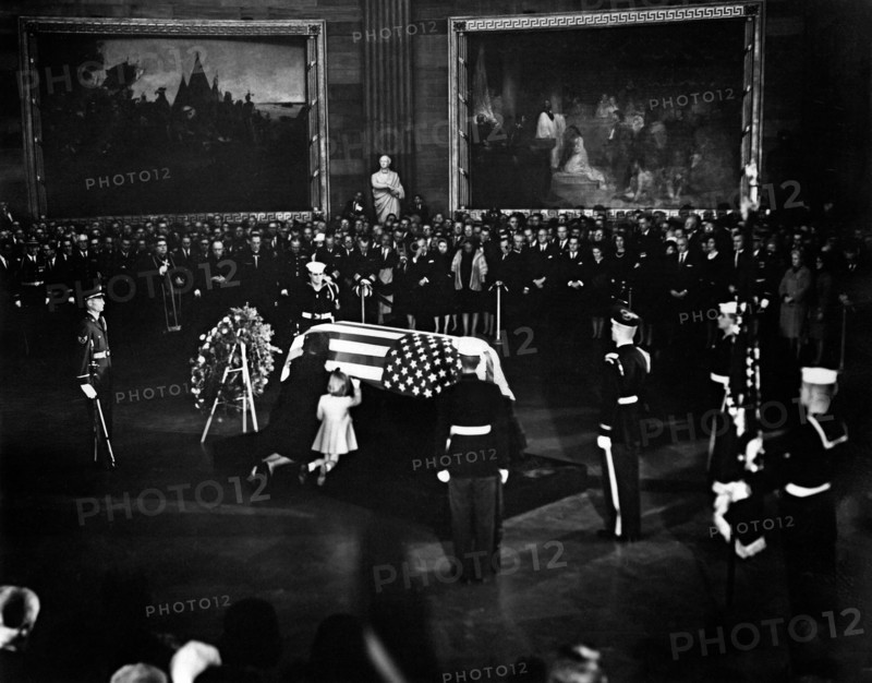 Jacqueline Kennedy and daughter Caroline Kennedy kneel and kiss U.S. President John F. Kennedy's flag-draped casket in center of Rotunda, U.S. Capitol Building, Washington, D.C., USA, Abbie Rowe, White House Photographs, November 24, 1963