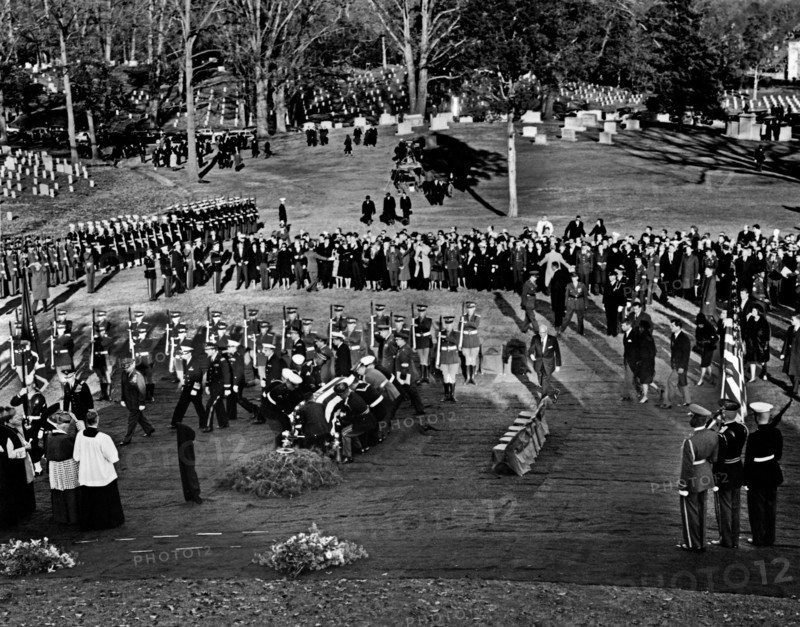 Kennedy family members: U.S. Attorney General Robert F. Kennedy, Jacqueline Kennedy, U.S. Senator Edward M. Kennedy, Rose Fitzgerald Kennedy, Steven Smith, Peter Lawford, Jean Kennedy Smith, Eunice Kennedy Shriver, follow as Honor guard pallbearers place the flag-draped casket of U.S. President John F. Kennedy at gravesite, during graveside services in the state funeral of President Kennedy, Arlington National Cemetery, Arlington, Virginia, USA, Abbie Rowe, White House Photographs, November 25, 1963