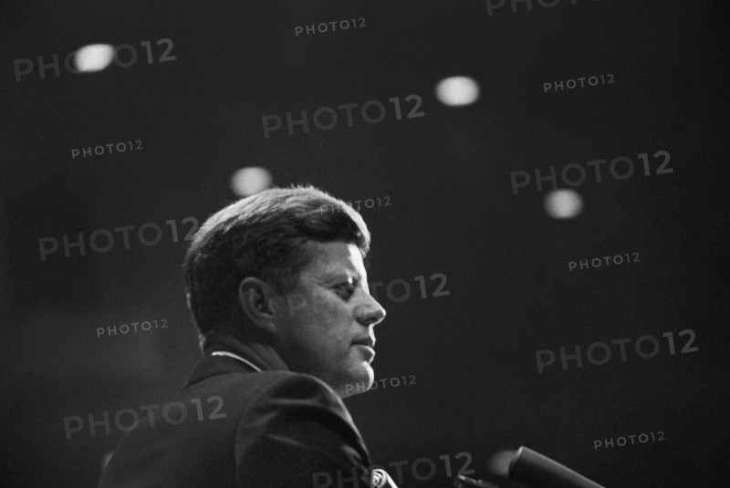 Head and shoulders portrait of U.S. President John F. Kennedy delivering remarks at dinner in honor of Representative Albert Thomas of Texas, Houston Coliseum, Houston, Texas, USA, Cecil Stoughton, White House Photographs, November 21, 1963