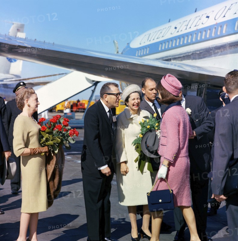 U.S. First Lady Jacqueline Kennedy  being greeted by (l-r): Elizabeth "Dearie" Cabell (with red roses), Dallas Mayor Earle Cabell, U.S. Second Lady Claudia "Lady Bird Johnson and U.S. Vice President Lyndon Johnson (mostly hidden behind Mrs. Kennedy), upon arrival at Love Field, Dallas, Texas, USA, Cecil Stoughton, White House Photographs, November 22, 1963