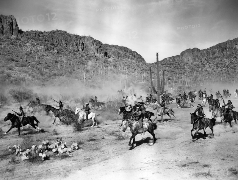 Apache Indians charging on horseback, on-set of the western film, "Arizona", Columbia Pictures, 1940
