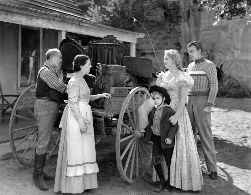 Scotty Beckett (small boy), Virginia Bruce (2nd right), Dennis O'Keefe (right), on-set of the western film, "The Bad Man Of Brimstone", Loew's Inc., 1937