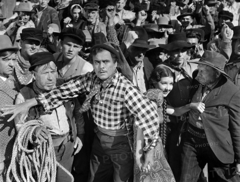 Leo Carrillo (foreground center), Jean Parker (right of Carrillo), on-set of the western film, "The Barrier", Paramount Pictures, 1937