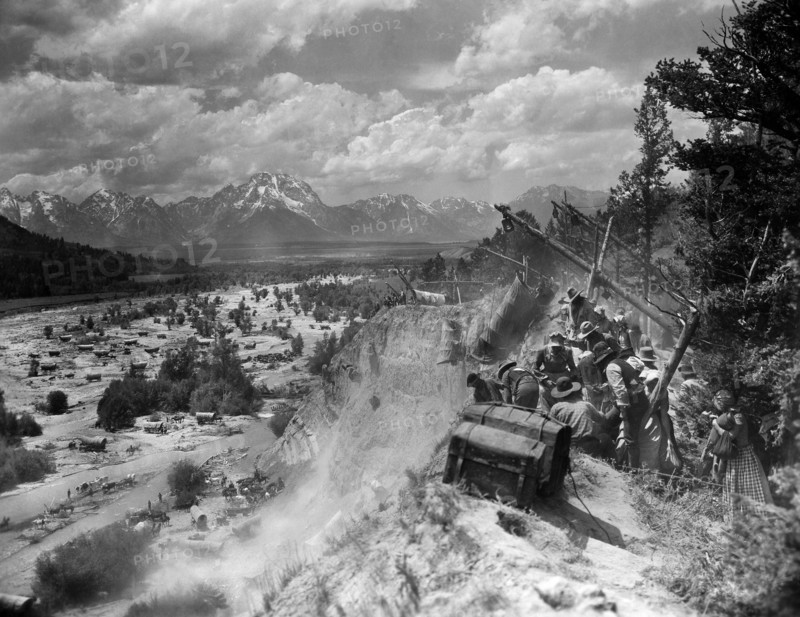 Caravan on Oregon Trail scene, on-set of the western film, "The Big Trail", Fox Film Corporation, 1930