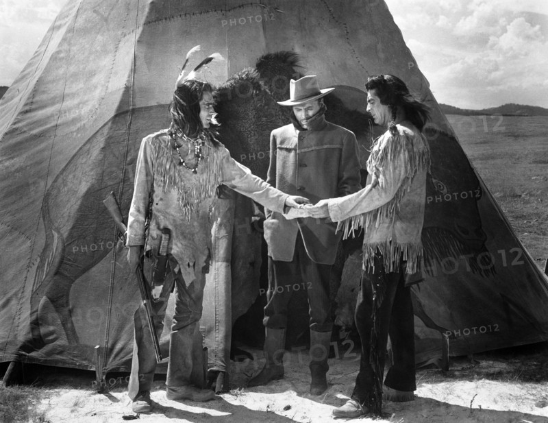 Keith Larson (left), John Lund (center), Victor Mature (right), on-set of the western film, "Chief Crazy Horse", Universal Pictures, 1955