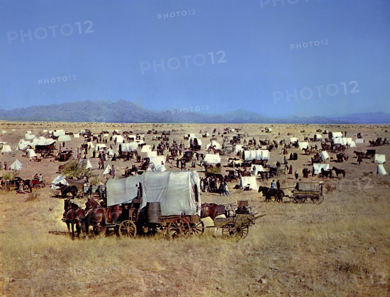 Covered wagons during Oklahoma land rush, on-set of the western film, "Cimarron", MGM, 1960
