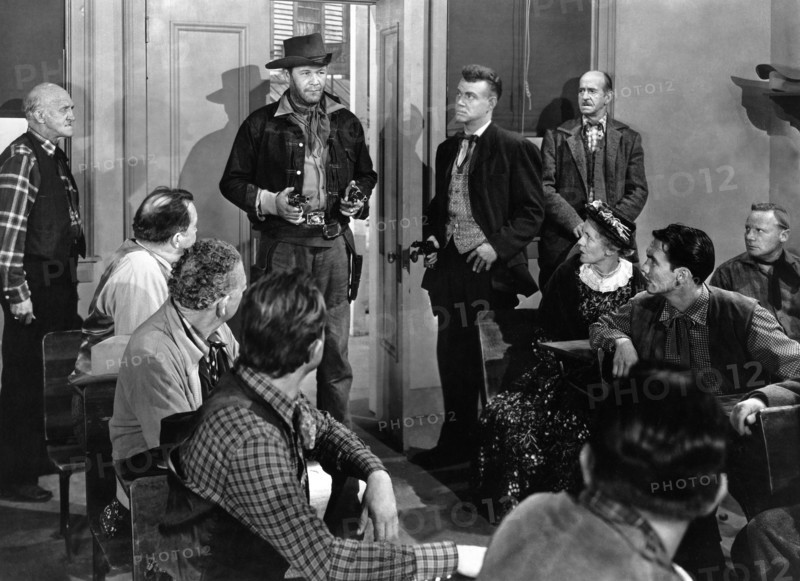Wayne Morris (standing center holding two handguns), on-set of the western film, "The Desperado", Allied Artists, 1954