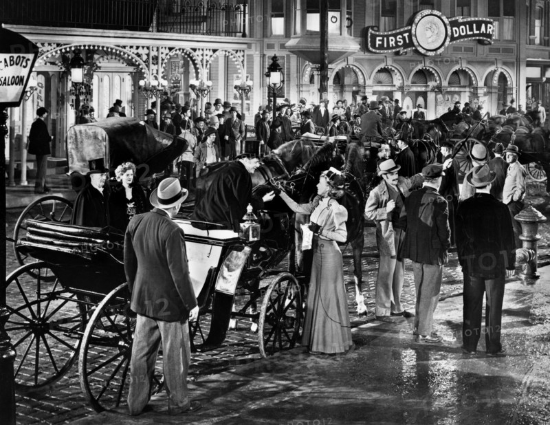 Susanna Foster (standing with hand extended next to horse-drawn carriage), on-set of the western film, "Frisco Sal", Universal Pictures, 1945